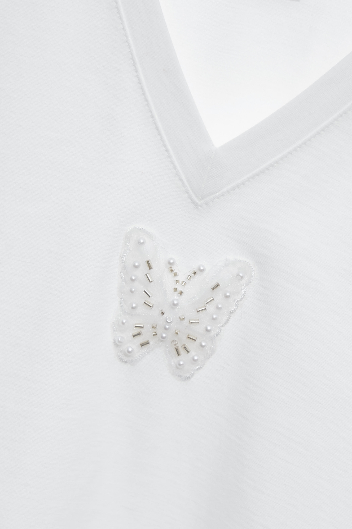 綴睫毛蕾絲袖Ｔ恤上衣綴睫毛蕾絲袖Ｔ恤上衣,上衣,春夏穿搭,白色上衣,蕾絲,蝴蝶結