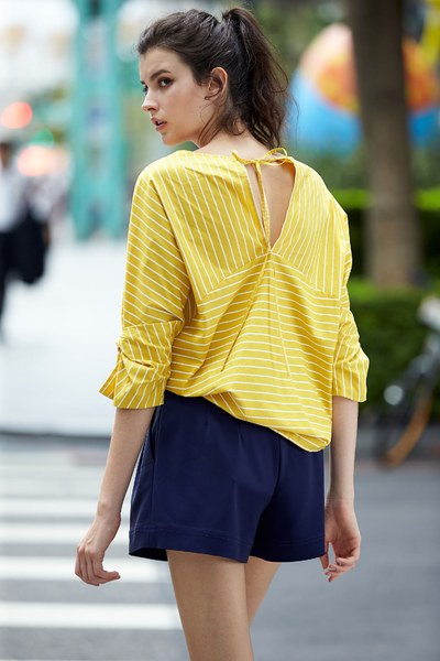 Energetic yellow top with knot sleeves